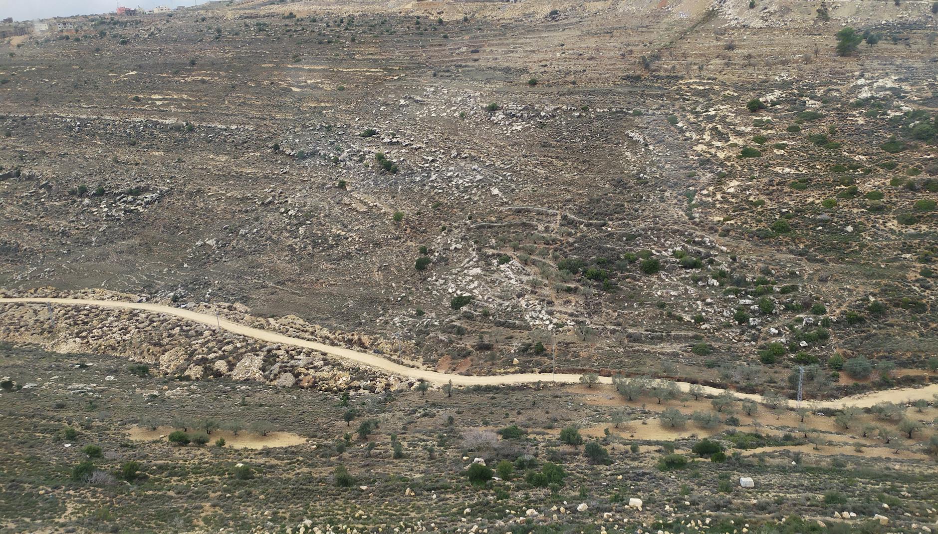 aerial view of dirt road on desert